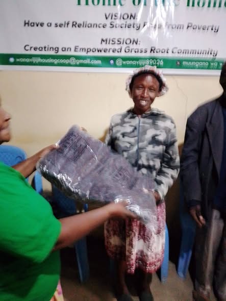 Richie Githatu with Wanavijiji Housing Cooperative Society members during a solidarity engagement in Nakuru